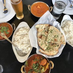 Various dishes and beverages arranged on a table.