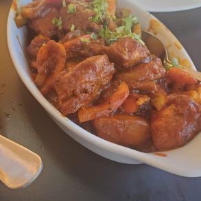 A plate of food with meat and vegetables, a delicious and nutritious meal.